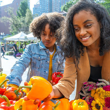 Selecting produce at a New York City, New York, farmers market