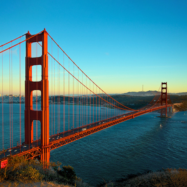 Low light illuminates the iconic Golden Gate Bridge in San Francisco, California