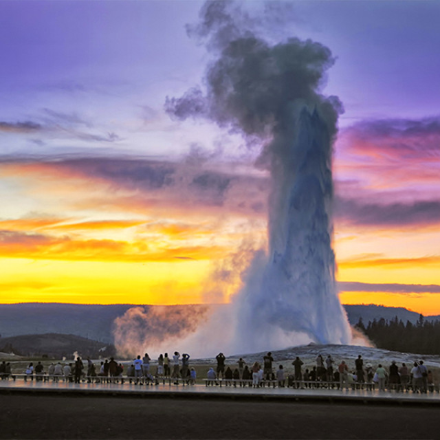 Admiring the "Old Faithful" geyser in Yellowstone National Park, Wyoming