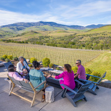 A group enjoys wine on the grounds of Irvine & Roberts Vineyards in Ashland, Oregon