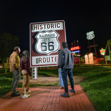 A group admires the neon signs at Route 66 Legends Neon Park at the Illinois State Fairgrounds in Springfield.